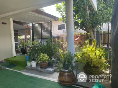 Charming garden area with lush greenery and cozy outdoor space, perfect for relaxation and entertaining.