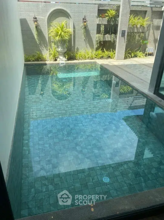 Luxurious private pool with modern design and lush greenery