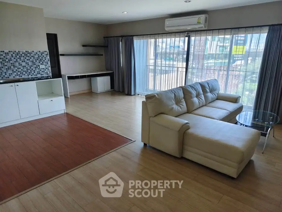 Spacious living room with modern design and large windows for natural light.