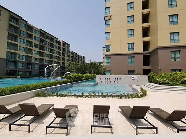 Luxurious apartment complex with poolside view and modern amenities.