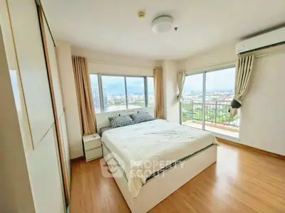 Spacious bedroom with panoramic city view and modern furnishings