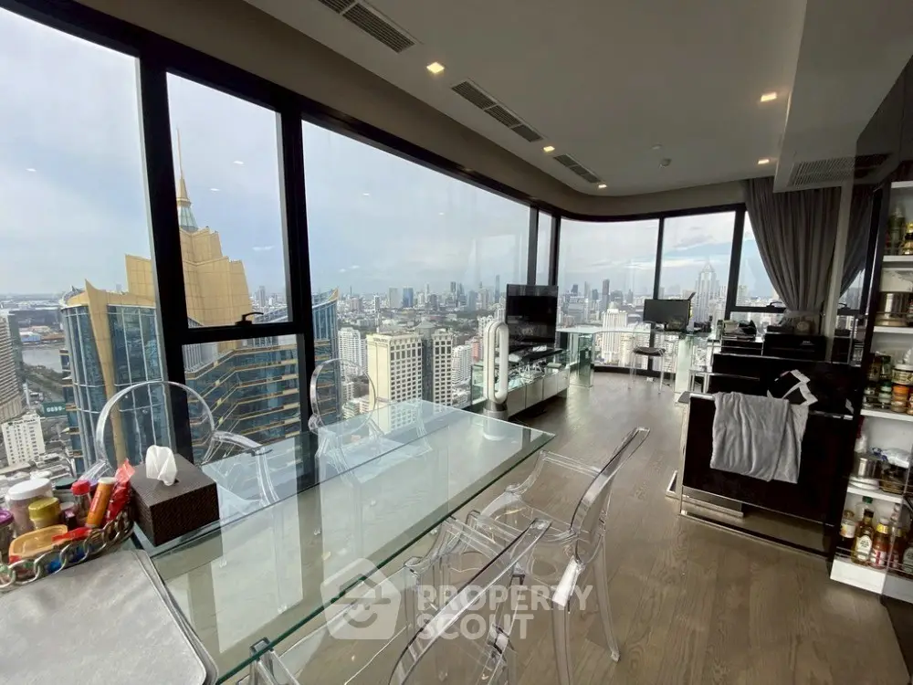Luxurious high-rise living room with stunning city skyline views and modern glass dining table.