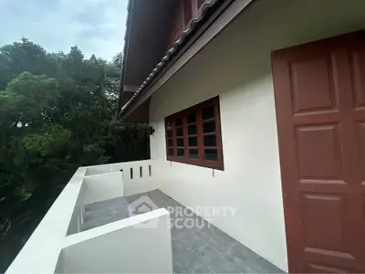 Charming balcony with forest view in a serene residential property