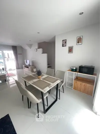 Modern dining area with sleek furniture and open layout in a bright, stylish home.