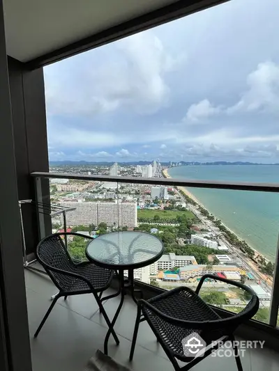 Stunning high-rise balcony with breathtaking ocean and city views, perfect for relaxation and enjoying the skyline.