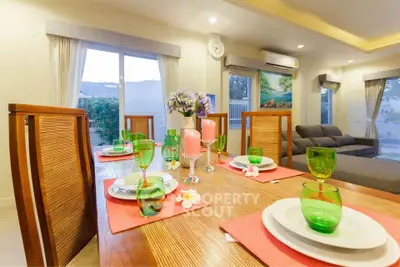 Elegant dining area with modern decor and large windows in a cozy living room setting.