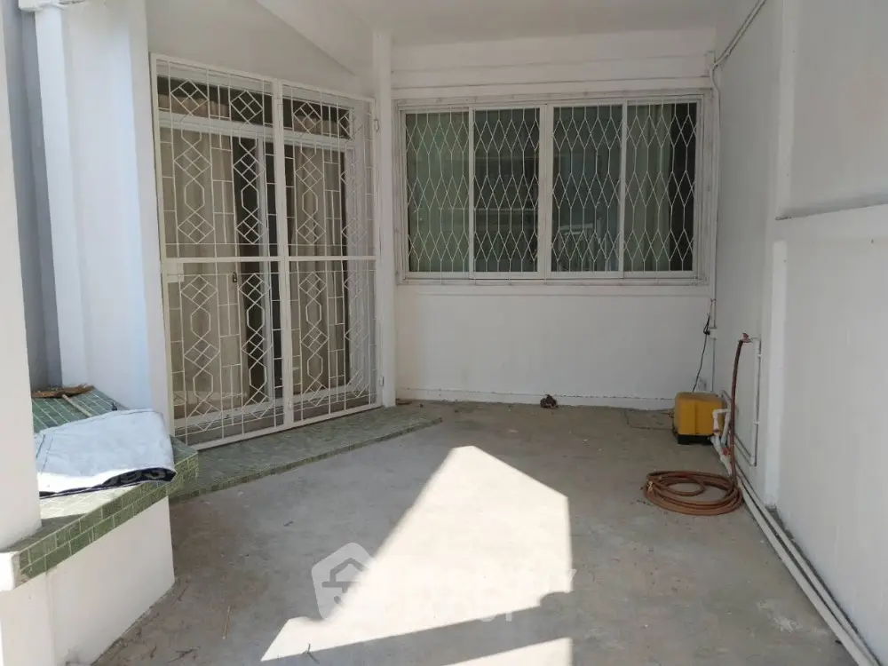 Spacious covered patio with security grills and ample natural light