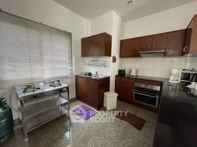 Spacious kitchen with modern appliances and ample storage in a stylish home.