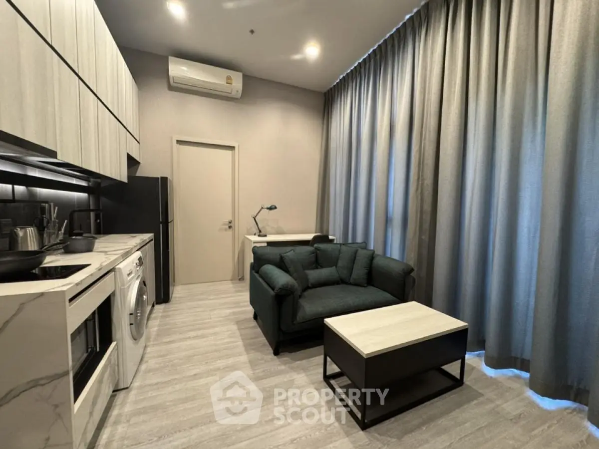 Modern studio apartment with sleek kitchen and cozy living area
