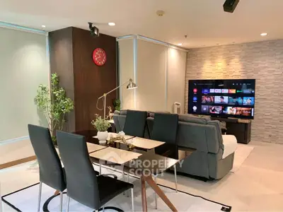 Modern living room with sleek dining area and large TV, perfect for entertainment.