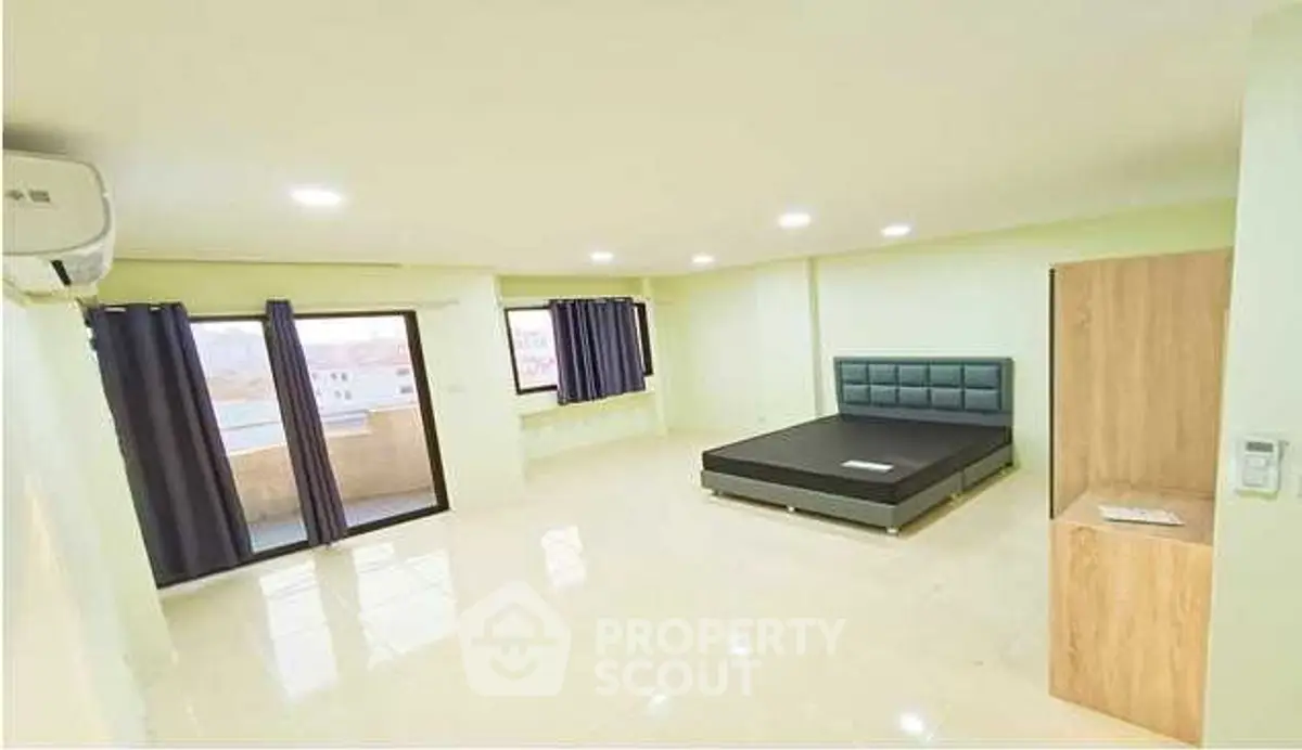 Spacious bedroom with modern design and large windows for natural light