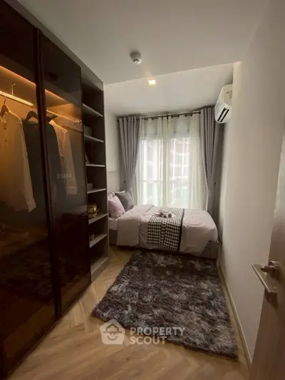 Cozy bedroom with modern wardrobe and plush rug in stylish apartment