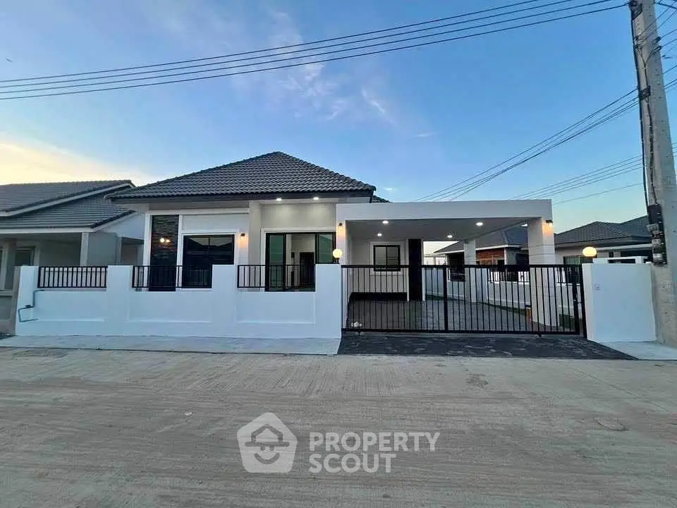 Modern single-story house with sleek design and spacious driveway, perfect for family living.