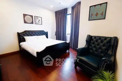 Elegant bedroom with dark leather furniture and stylish decor