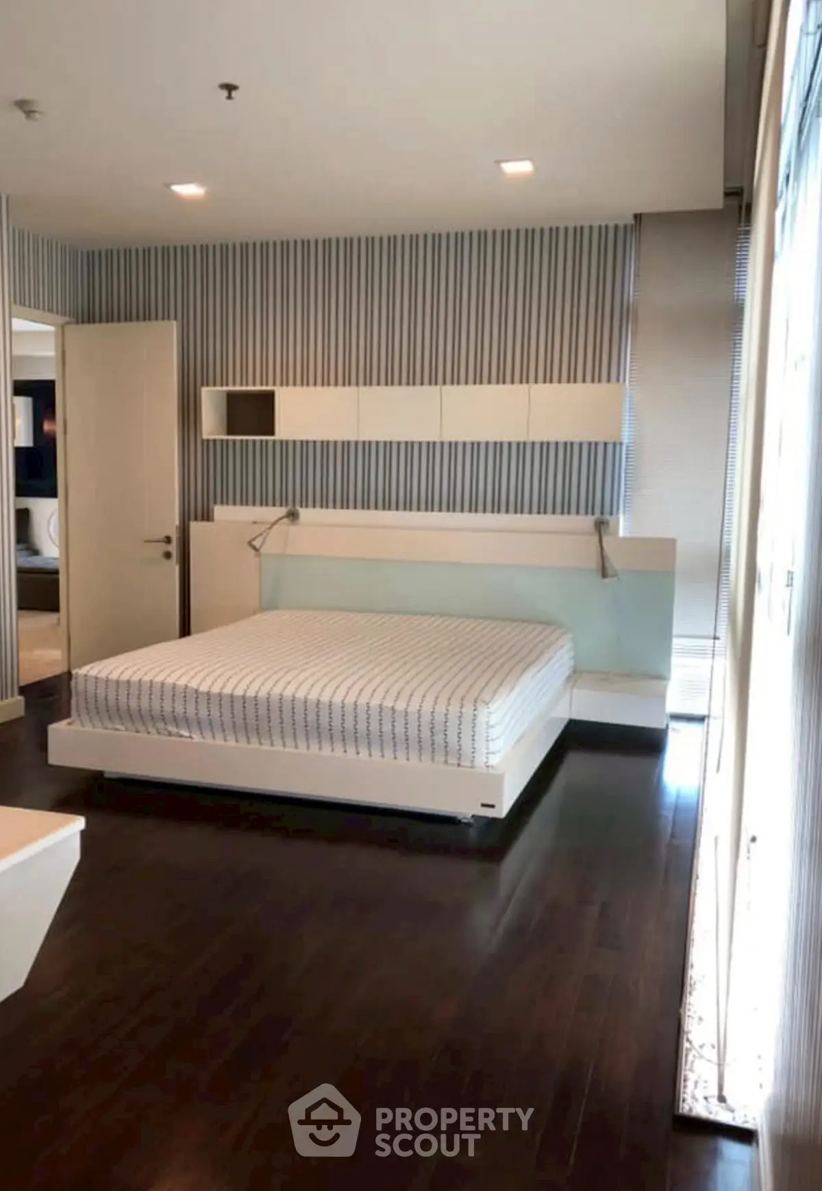 Modern bedroom with sleek design and dark wood flooring