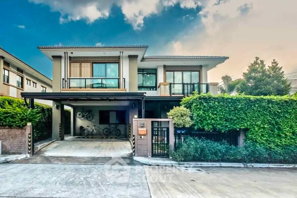 Modern two-story house with lush greenery and spacious driveway