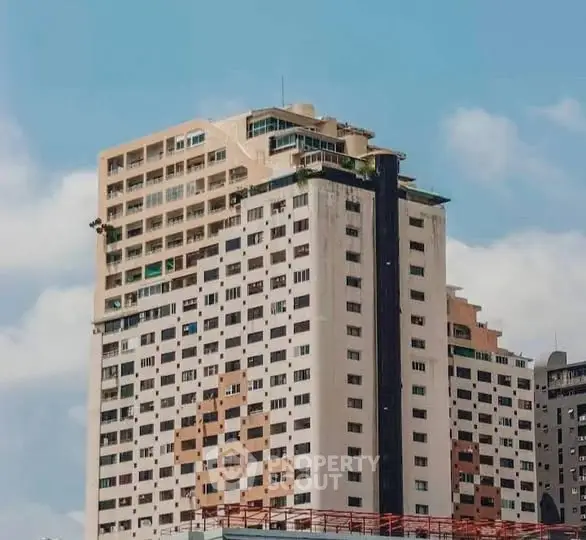 Stunning high-rise building with modern architecture against a clear blue sky.