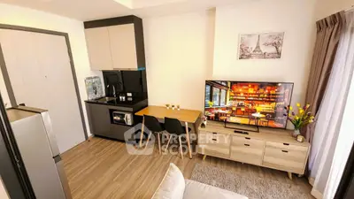 Modern studio apartment with sleek kitchen and cozy living area, perfect for urban living.