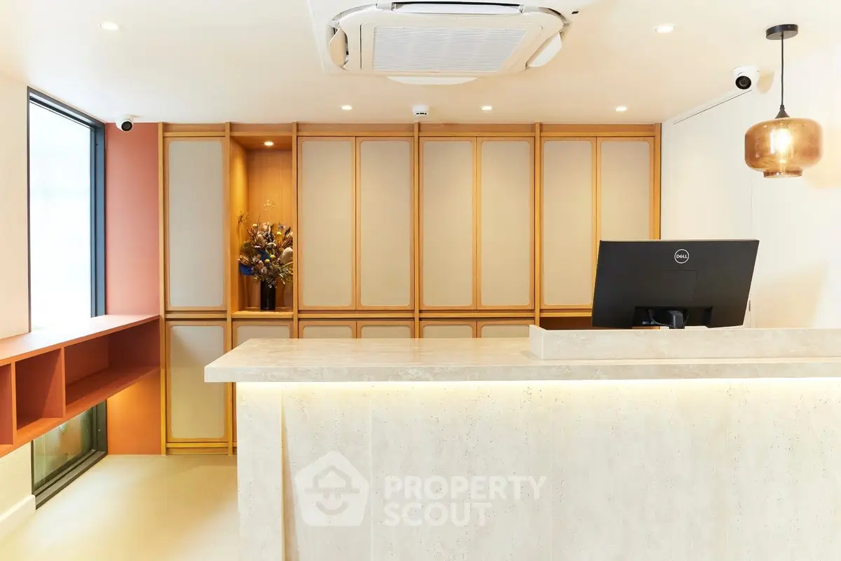 Modern reception area with elegant lighting and sleek design, perfect for welcoming guests.