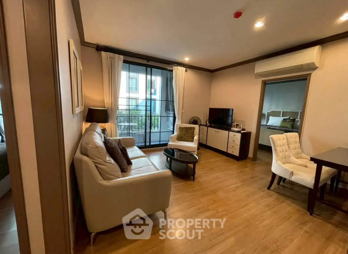 Spacious living room with modern furniture and large windows in a stylish apartment.