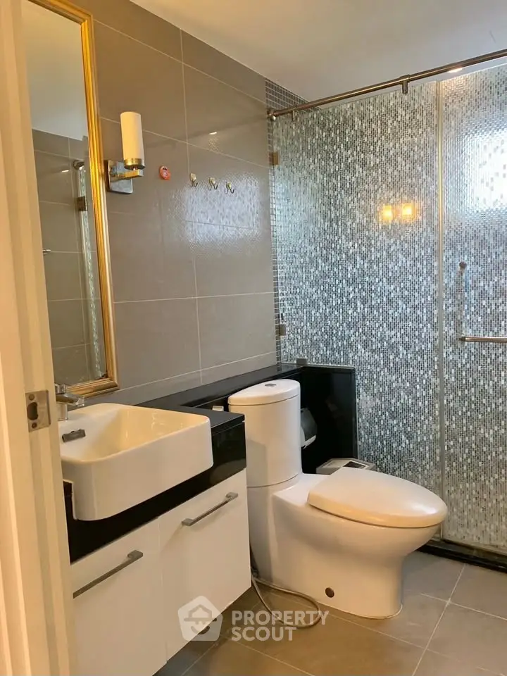 Modern bathroom with sleek fixtures and glass shower enclosure