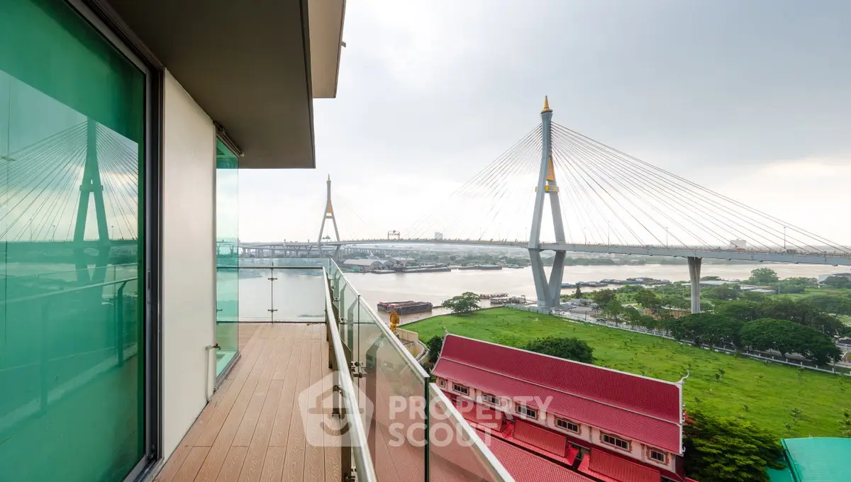 Stunning balcony view of iconic bridge and river, perfect for urban living enthusiasts.