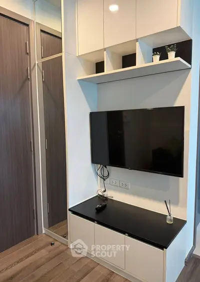 Modern living room with sleek TV setup and stylish storage solutions