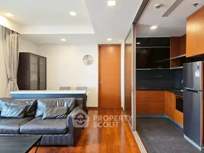 Modern open-plan living room with sleek kitchen and stylish decor