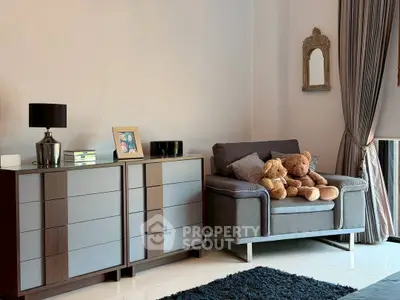 Cozy living room with modern furniture and plush teddy bears, perfect for relaxation.
