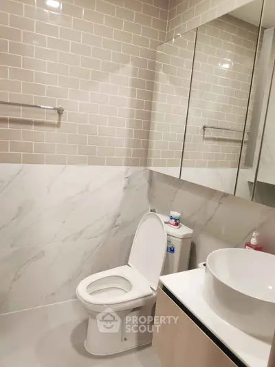 Modern bathroom with elegant tile design and sleek fixtures