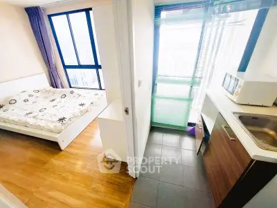 Modern studio apartment with cozy bedroom and compact kitchen