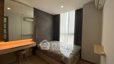 Modern bedroom with large window and stylish decor in a high-rise apartment.