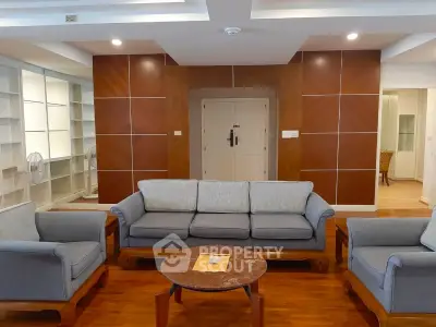 Spacious living room with elegant wooden flooring and modern furniture