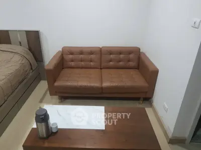 Cozy living room with brown leather sofa and wooden coffee table