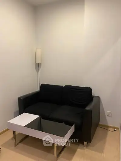 Cozy modern living room with black sofa and sleek coffee table