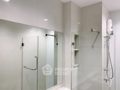 Modern bathroom with glass shower and sleek fixtures