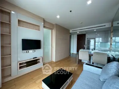 Modern living room with sleek furniture and open kitchen layout