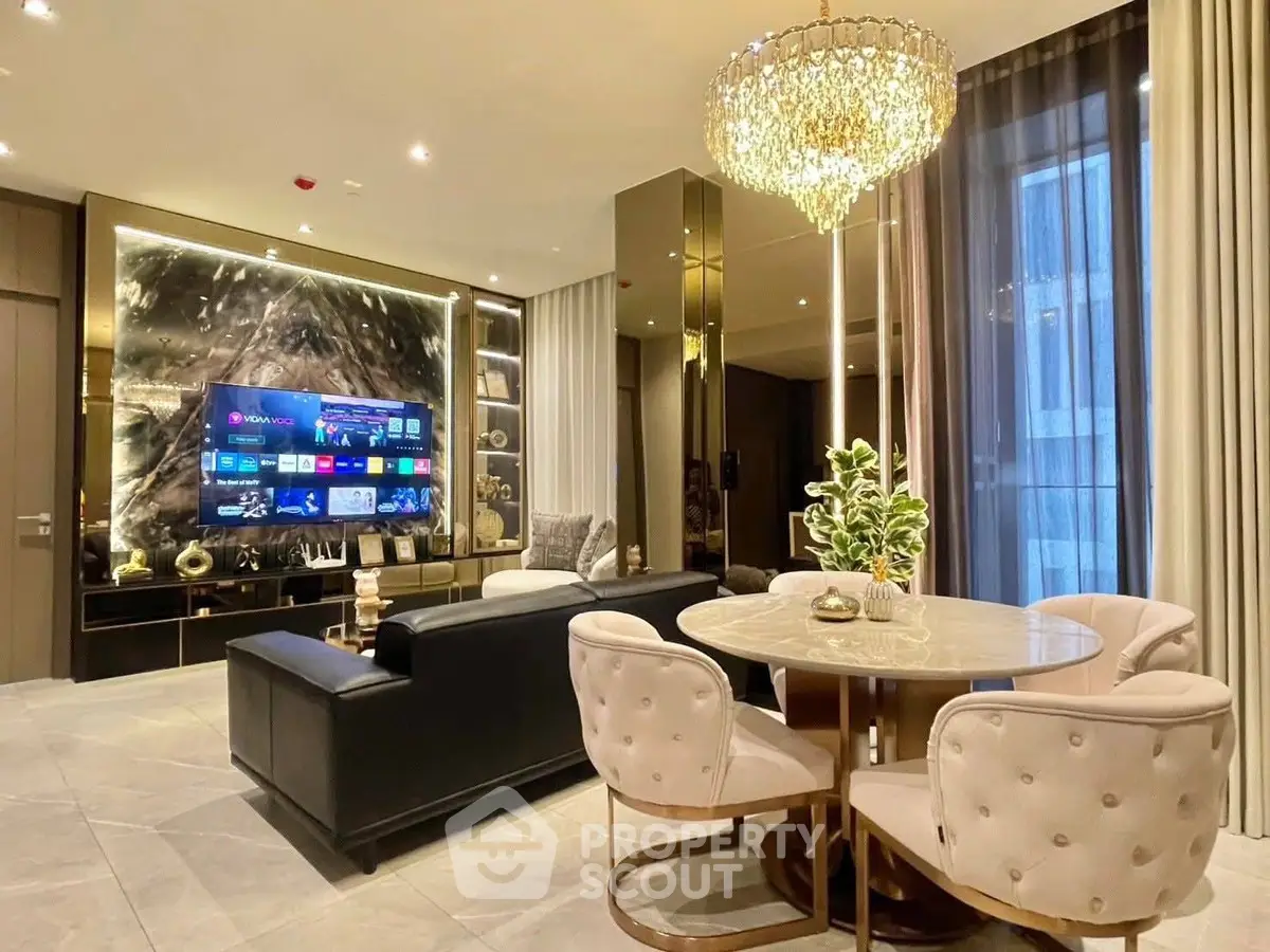 Luxurious living room with elegant chandelier and modern entertainment setup