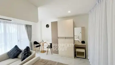 Modern studio apartment with cozy living area and stylish decor