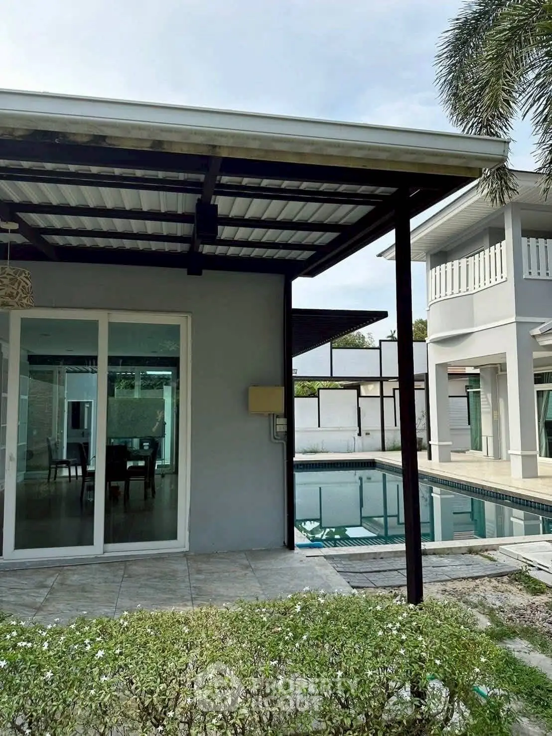 Modern home with poolside view and elegant patio design