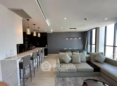 Luxurious open-plan living room with modern kitchen and panoramic city views.