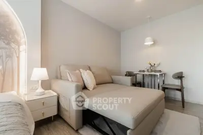 Modern living room with stylish furniture and elegant dining area in a cozy apartment.