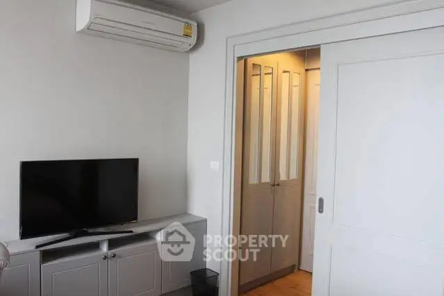Modern living room with air conditioning and sliding door closet