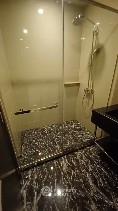 Luxurious bathroom with elegant marble flooring and modern shower design