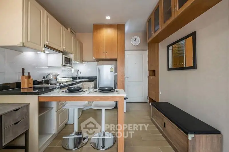 Modern kitchen with sleek design, featuring an open layout and stylish bar seating.
