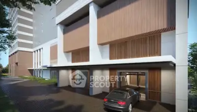 Modern building exterior with car entrance and sleek design elements.