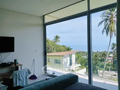 Luxurious living room with stunning ocean view through large glass windows
