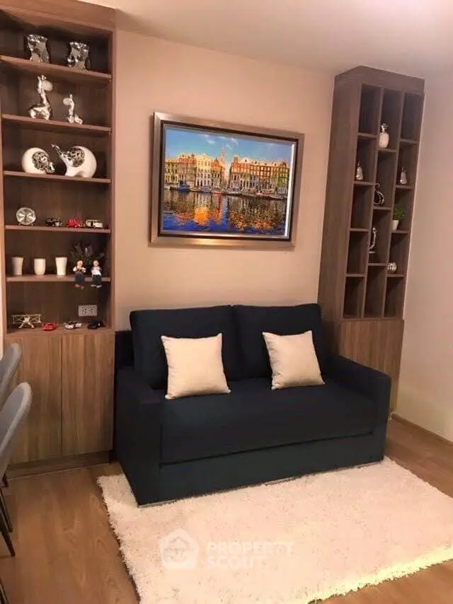 Charming living room with stylish shelving and cozy sofa, perfect for relaxation and entertaining.