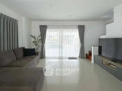 Spacious modern living room with large windows and stylish decor