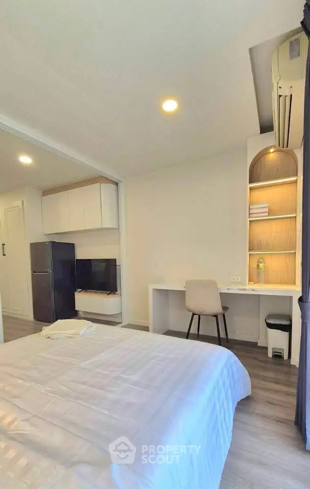 Modern bedroom with study area and sleek design in a cozy apartment